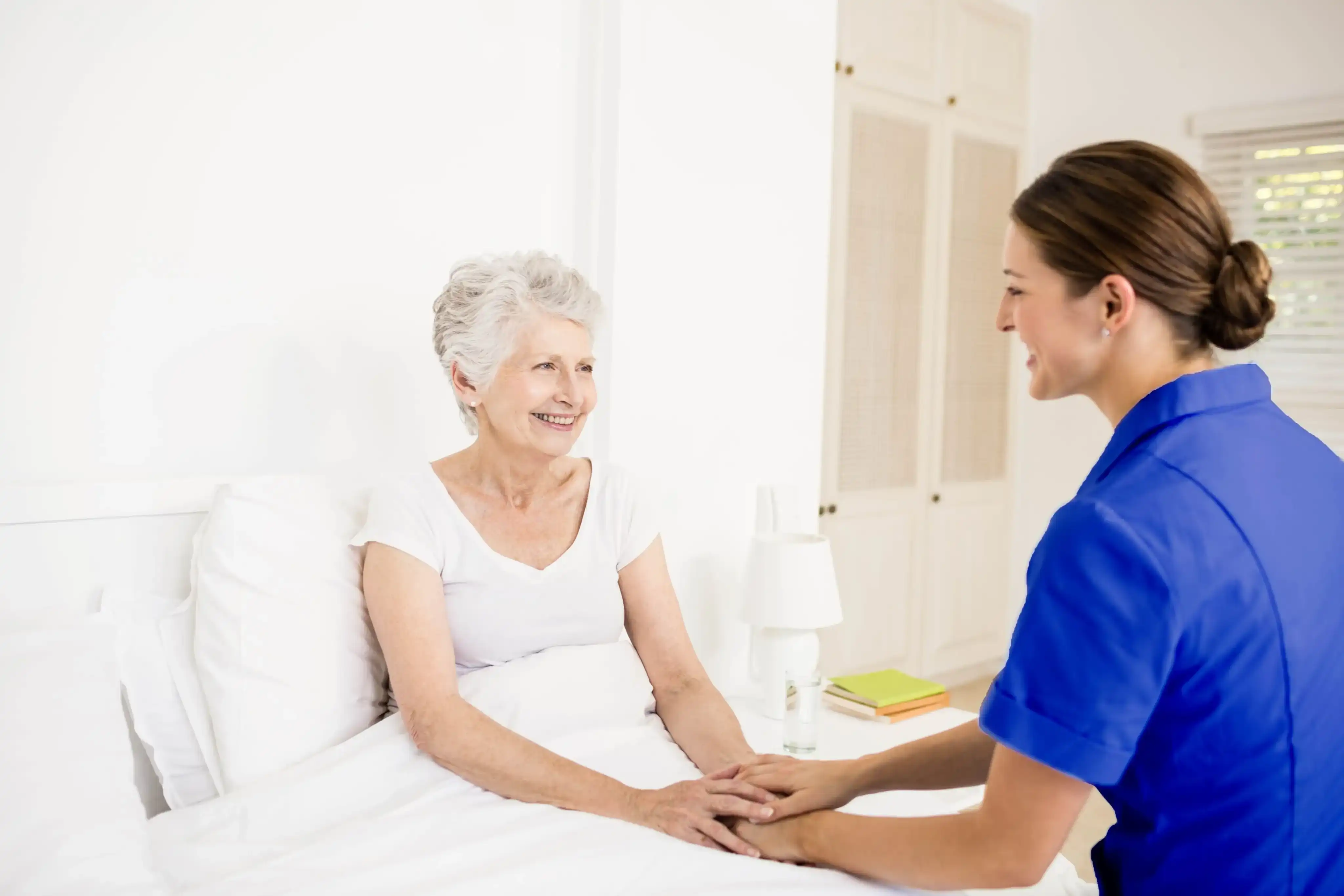 our nurse and elderly woman holding hands