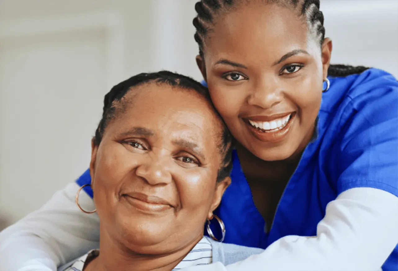 nurse and elderly woman smiling for a pic